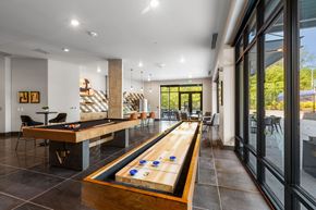 Federal Way apartment for rent - a game room with a shuffleboard table and a pool table
