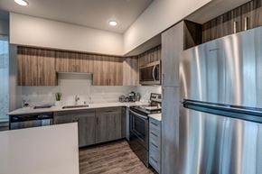 Maple Valley apartment for rent - a kitchen with stainless steel appliances and wooden cabinets