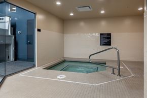 Tacoma apartment for rent - A small indoor pool with a glass door entrance.