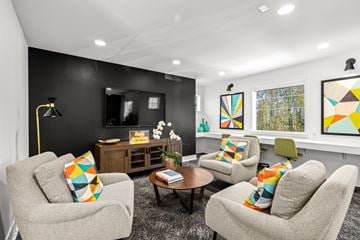Seattle apartment for rent - A living room with grey chairs and a coffee table.