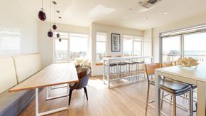 Seattle apartment for rent - a dining room with a wooden table and chairs and a balcony