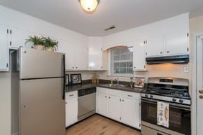 North Chesterfield apartment for rent - A kitchen with white cabinets and a stainless steel refrigerator.