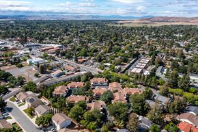 Concord apartment for rent - an aerial view of a neighborhood of houses with trees in the foreground and mountains in the background at Greentree Terrace Apartments, California, 94521