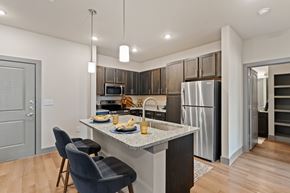 Houston apartment for rent - A modern kitchen with a dining table set for two.