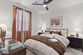 Humble apartment for rent - A bedroom with a large bed and a ceiling fan.