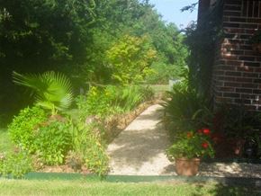 Lafayette apartment for rent - a pathway in a garden next to a brick building