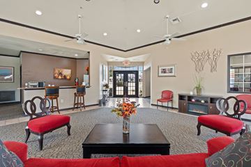 Denton apartment for rent - A living room with a red couch and a black coffee table.