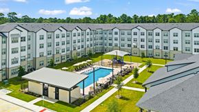 Humble apartment for rent - Aerial view of courtyard pool and resident buildings at Tapestry Woodland Hills Apartments, Humble, TX 77346