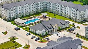 Humble apartment for rent - Aerial view of courtyard pool and surrounding buildings at Tapestry Woodland Hills Apartments, Humble, TX