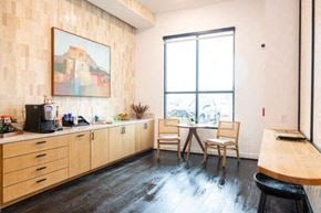 Del Valle apartment for rent - A kitchen with wooden cabinets and a painting on the wall. at Enclave on Ross Apartments, Texas, 78617