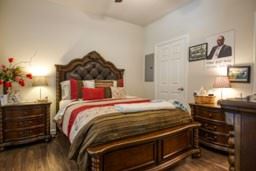 Cuero apartment for rent - A bedroom with a large bed and a wooden dresser.
