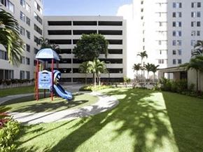 Honolulu apartment for rent - a playground with a slide in front of a building