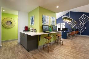 Austin apartment for rent - A kitchen with a white counter and bar stools.