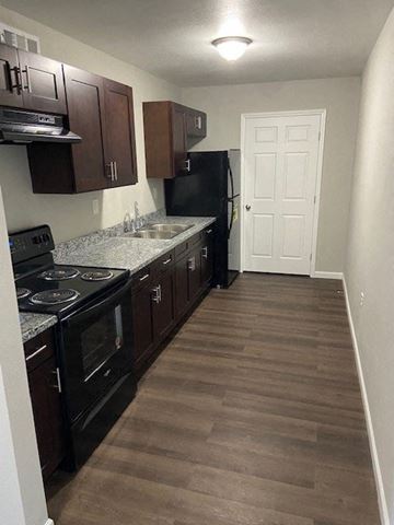 Thibodaux apartment for rent - a kitchen with a stove a sink and a refrigerator