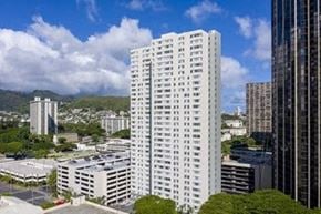 Honolulu apartment for rent - a tall white building sitting in the middle of a city