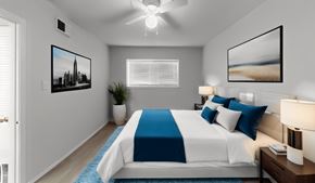 Austin apartment for rent - a bedroom with a large bed and a ceiling fan