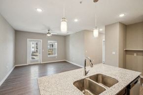 Lockhart apartment for rent - A kitchen with a sink and a ceiling fan at Lockhart Farms Apartments, Lockhart 78644