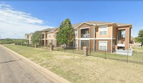 San Angelo apartment for rent - A row of houses with a black fence in front.