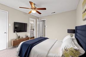 Arlington apartment for rent - a bedroom with a large bed and a ceiling fan