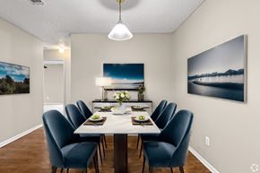 Arlington apartment for rent - a dining room with a white table and blue chairs
