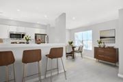 Austin apartment for rent - an open kitchen and dining area with bar stools and a table with chairs