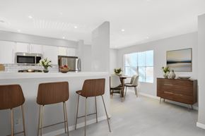 Austin apartment for rent - an open kitchen and dining area with bar stools and a table with chairs