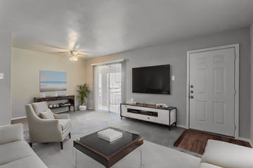 Dallas apartment for rent - a living room with a white couch and a television