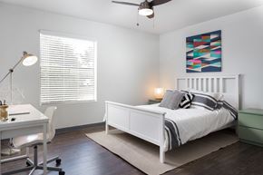 Austin apartment for rent - A bedroom with a bed, desk, and chair.
