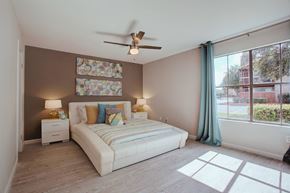 Austin apartment for rent - a bedroom with a bed and a ceiling fan