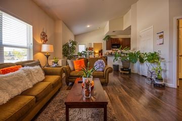 Cuero apartment for rent - A living room with a brown sofa and a wooden coffee table.