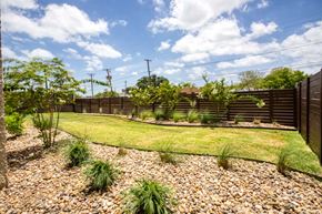 Corpus Christi apartment for rent - a backyard with a grass lawn and a fence