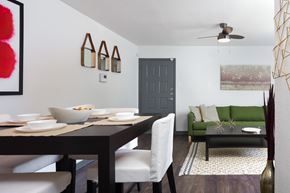Austin apartment for rent - A dining room with a table set for two and a green couch.