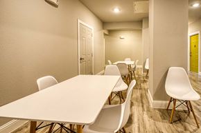 Corpus Christi apartment for rent - a long row of white tables and chairs in a large room
