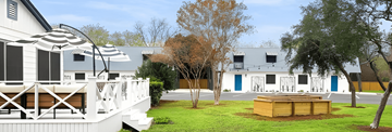 San Antonio apartment for rent - A white house with a deck and a hot tub.