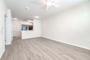 Gambrills apartment for rent - A spacious room with a ceiling fan and lighting fixtures.