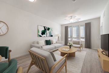 Gambrills apartment for rent - A living room with a sofa set, a coffee table, and a television.