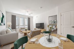 Gambrills apartment for rent - A modern dining room with a wooden table set for two.