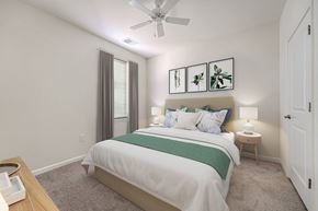 Gambrills apartment for rent - A bedroom with a bed, nightstand, and a ceiling fan.