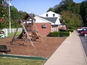 Parkersburg apartment for rent - a wooden swing set in a yard in front of a house