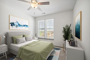 Ashburn apartment for rent - a bedroom with a green bed and a ceiling fan