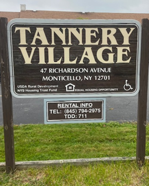 Monticello apartment for rent - A sign for Tannery Village with a phone number and address.