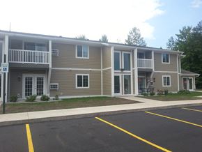 Munising apartment for rent - an apartment building with a parking lot in front of it