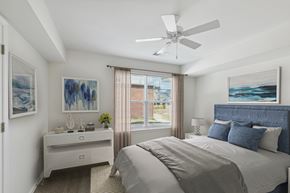 Queenstown townhouse for rent - a bedroom with a large bed and a ceiling fan