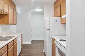 Bluefield apartment for rent - A kitchen with wooden cabinets and white appliances.
