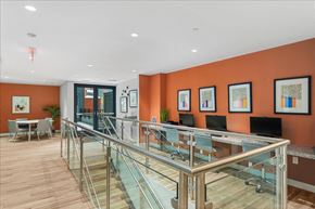 Washington apartment for rent - a conference room with a glass table and chairs and orange walls