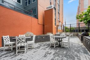 Washington apartment for rent - a patio with tables and chairs outside of a building
