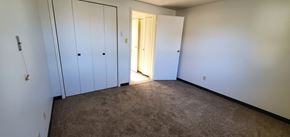 Leroy, Genesee County apartment for rent - a bedroom with two closets and a door to a hallway