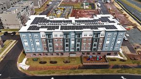 Ashburn apartment for rent - an aerial view of an apartment building with solar panels on the roof