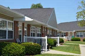 Waverly apartment for rent - a row of houses with a porch and a white fence