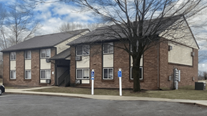 Moweaqua apartment for rent - a brick house with a tree in front of it